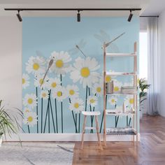 daisies and dragonflies on a blue wall mural in a room with wooden floors