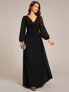 a woman in a long black dress with sleeves on her shoulders and an open neckline