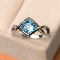 a ring with a blue topazte in it