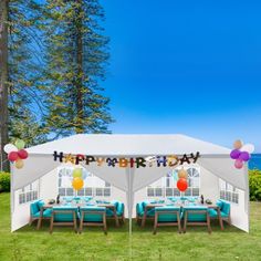 a birthday party tent with balloons and streamers