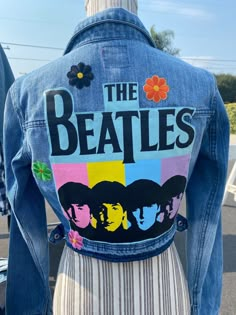 a jean jacket with the beatles on it