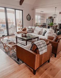 a living room filled with furniture and a large window