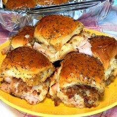 several sliders on a yellow plate with red and white checkered table cloth next to them