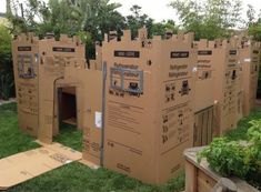 a cardboard castle made to look like it is in the grass