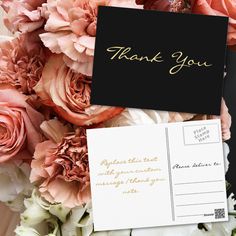 a bouquet of flowers with a thank you card and envelope on top that says,'thank you '