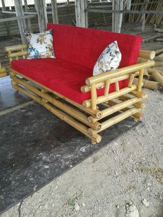 a red couch sitting on top of a wooden frame