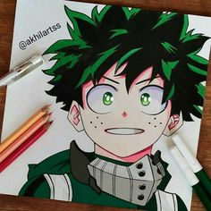 a drawing of an anime character with green eyes and black hair on a piece of paper next to colored pencils