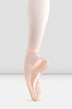 the feet of a ballerina in pink ballet shoes