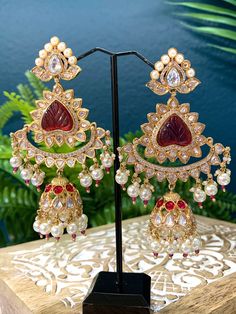 Premium quality High gold plated, pearl work, hand carved work , AD lining and kundan work. Clip back.  about 5 inch long  Absolute designer piece and statement earring. Luxury Red Traditional Chandelier Earrings, Luxury Red Kundan Jhumkas, Luxury Red Kundan Chandbalis, Kundan Chandbali, Kundan Work, Pearl Work, Chandbali Earrings, Statement Earring, Anklet Jewelry