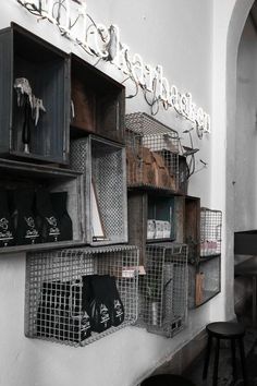 the shelves are filled with various items in baskets on them, and hanging from the wall