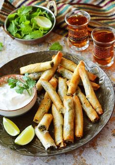 a plate full of food with dipping sauce on the side