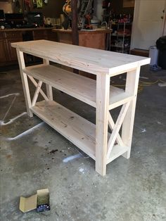 a wooden table sitting inside of a garage