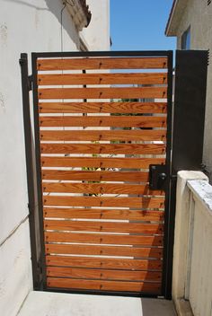 an open wooden gate on the side of a building with words above it that read, appreciate the look of more modern architecture than wood