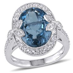 Look resplendent with this flattering  London Blue and White Topaz Halo Ring. Crafted in lustrous sterling silver, this stunning halo ring features a central oval-cut bezel-set London blue topaz gemstone (14x10mm) encased in a halo design created by 30 round-cut pave-set white topaz gemstones (1.5x1.5mm) and six round-cut pave-set diamonds (G-H, I2-I3). Enhanced with a polished finish, this striking ring will set you apart. Wear this versatile ring for special occasions. Silver Halo Ring, Diamond Accent Ring, London Blue Topaz, London Blue, Topaz Gemstone, Topaz Ring, White Topaz, Cocktail Ring, Diamond White