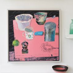 there is a painting on the wall next to a bowl and vases in front of it