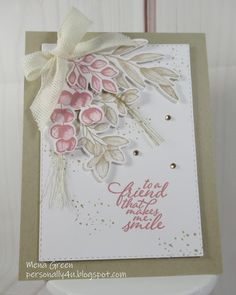 a close up of a greeting card with flowers on the front, and an embellishment in the back