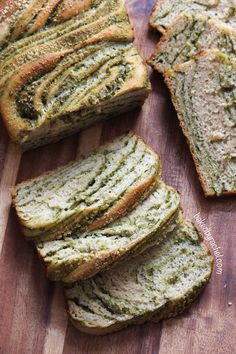 slices of bread on a cutting board with pesto