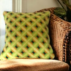 a green and yellow pillow sitting on top of a chair