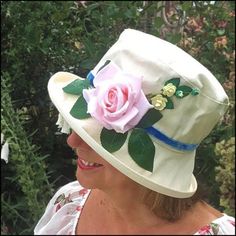 A true English romantic’s hat: think "Downton Abbey" with extra glamour given by the the pink rose flowers and the luxurious velvet ribbon.  SO comfortable on a hot day too as it's handmade with 100% breathable cotton.The neat boned brim gives shade and protection. - but isn't overpowering if you are petite.Very English in design and style and just perfect for a summer wedding - but also for making an impact at any glamorous holiday destination, an outdoor concert or special church event!One of Light Pink Rose, Outdoor Concert, Pink Rose Flower, Summer Rose, Rosé Details, Sun Hats For Women, Summer Hat, Rose Flowers, Downton Abbey