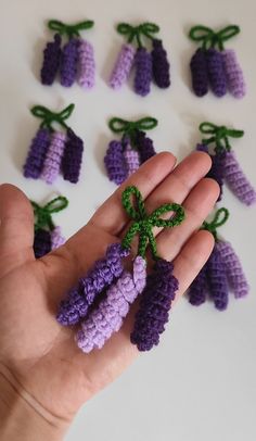 small crocheted flowers are being held by a hand