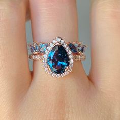 ✦Gorgeous London Blue Topaz Ring 2 Piece Set✦ ✧ Base Metal: 925 Sterling Silver ✧ Plating: 14K Rose Gold Vermeil ✧ Accented with Natural Crystals ✧ Average band width: 2.1 mm ✧ Center Stone: Topaz ✧ Color: London Blue ✧ Stone Cut: Pear ✧ Gem size: 8.0 x 6.0 mm ✧ Carat Weight: 1.21 ct. ✧ Gemstone creation: Natural ✧ Hardness: 8 (Mohs scale) ✧ Gemstone Origin: Switzerland ✧ Sizes 3.5-11.25 ✧ This ring set will arrive ready to gift in a Kherish Box. ✧ Due to the nature of the handmade process, each piece may slightly vary in color, size, shape, and contain natural inclusions. Every piece is gorgeous and one of a kind. *Please refer to photos for reference.  ✦ This Artist Has Autism✦ Every item you order from Kherish is handcrafted and packed by an artist with autism in RVA. Thanks to your sup London Blue Engagement Ring, Black Gold Engagement Rings, Blue Topaz Engagement Ring, Birthday Vintage, Mohs Scale, Topaz Engagement Ring, London Blue Topaz Ring, Topaz Color, Rings Rings