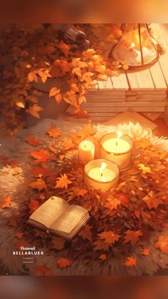 an open book sitting on top of a pile of leaves next to two lit candles