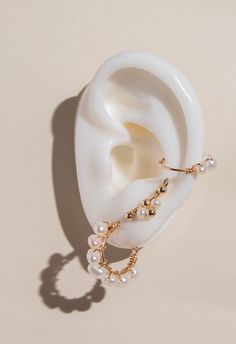 Indulge in luxury with our Maia Pearl Hoops. These handcrafted earrings feature stunning Maia pearls, exuding elegance and sophistication. Elevate any look with these exclusive hoops, perfect for any occasion. Feel like a true fashion icon with Maia Pearl Hoops. Details: Material: 14k Gold-Filled Gemstone: freshwater pearl Handcrafted Water Resistant Hypoallergenic and Tarnish resistant Luxury Pearl Jewelry With Pierced Design, Elegant Hoop Clip-on Earrings, Elegant Hoop Wrap Earrings For Pierced Ears, Chic Pearl Jewelry With Matching Earrings, Elegant Round Ear Cuff, Elegant White Ear Cuff For Formal Occasions, Elegant Hoop Ear Cuff With Ear Wire, Elegant Hoop Clip-on Earrings For Wedding, Elegant Gold Ear Cuff With Pearl Drop