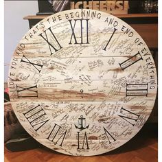 a large wooden clock with writing on it