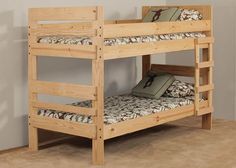 a wooden bunk bed sitting on top of a carpeted floor next to a wall