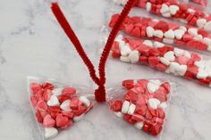 three bags filled with red and white candy hearts