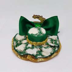 Gold and green mini hat for girls, adults and pets. Mini hat size is approximately 3.5 inches wide by 1.5 inches high. Mini hat can be attached to a metal alligator clip, a soft headband or ribbon for pets. Please choose the finish: -5/8 by 16 or 18 inches soft headband -2.6 inches metal alligator clip -3/8 by 18 or 25 inches ribbon (for pets) -you will receive a random deer pose -There may be slight variation in size -Ribbon placement may vary slightly from what is pictured -Due to lighting color may vary slightly -All mini hats are made in a smoke free environment -Every hat is handcrafted by me. *Please feel free to contact the seller if you have a question **Hats are ready to ship the next business day All mini hats will be shipped in a box. Holiday Hair Clips, Scarecrow Hat, Holiday Hair Bows, Golden Deer, Gold Hat, Mini Hats, Mini Hat, Fabric Hair Bows, Holiday Hair