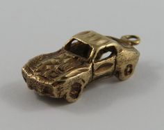 "This is a vintage \"Corvette Stingray\" 10 karat gold charm for a charm bracelet.  It weighs 2.50 grams and measures 3/8\" x 7/8\", marked \"10K\" All charms come with a split ring to attach to a bracelet. We have hundreds of charms in stock. If you don't see what you are looking for in our shop please contact us as it is likely we have it. Inventory #G2432" Vintage Yellow Gold Charms For Gift, Antique Brass Charms For Collectors, Collectible Yellow Gold Charms With Vintage Charm, Collectible Yellow Gold Charms With Vintage Design, Antique Gold Charms For Collectors, Brass Vintage Charm For Collectibles, Vintage Engraved Brass Charms, Vintage 14k Gold Engraved Charms, Vintage Engraved 14k Gold Charms