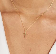 The 14K Solid Gold Small Cross Necklace is a symbol of faith, devotion, and timeless elegance. Crafted with meticulous attention to detail, this delicate piece features a tiny cross pendant made from 14K solid gold. Its simple yet profound design makes it a perfect religious necklace for women, suitable for various occasions such as baptisms, weddings, or as a thoughtful Mother's Day or birthday gift. As a symbol of one's faith and commitment, this cross necklace holds deep significance. It serves as a reminder of one's beliefs and values, offering strength, comfort, and inspiration to the wearer. Whether worn as a daily expression of spirituality or on special occasions to mark significant milestones, this necklace carries with it the blessings and well-wishes of the giver. For a bride, t Yellow Gold Cross Necklaces For Baptism, Classic Crucifix Jewelry For First Communion, 14k Gold Cross Necklaces For Baptism, 14k Gold Cross Necklace For Baptism, Classic Cross Pendant Jewelry For First Communion, Dainty 14k Gold Jewelry For Baptism, Classic Cross Jewelry For Baptism, Yellow Gold Jewelry For First Communion, Dainty Cross Pendant Jewelry For First Communion