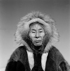 an old man wearing a fur coat and hood