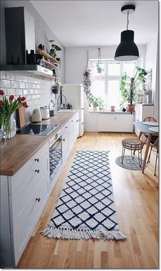 the kitchen is clean and ready to be used for cooking or dining, with lots of natural light coming in from the window