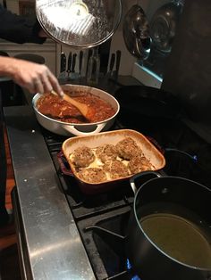 two pans filled with food sitting on top of a stove next to each other