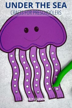 a paper cut out of a purple jellyfish with the words under the sea crafts for preschoolers