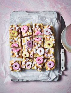 there is a tray full of donuts and marshmallows on the table