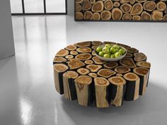 a table made out of tree slices with a bowl of fruit on top of it