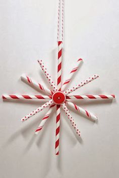 a red and white christmas ornament hanging on a wall with candy canes