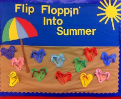 a bulletin board with flip flops and an umbrella in the sand for kids to play