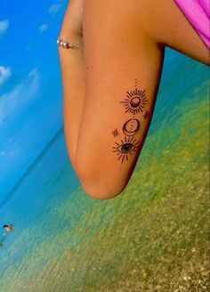 a woman's leg with a tattoo on it and the sun and moon behind her