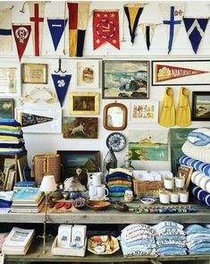 there are many items on the table in this room that is decorated with flags and pennants