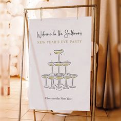 a new year's eve party sign with champagne glasses