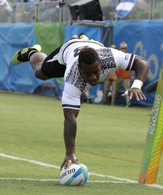 a man diving to catch a soccer ball