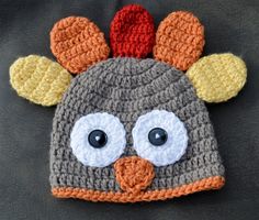 a crocheted turkey hat with big eyes