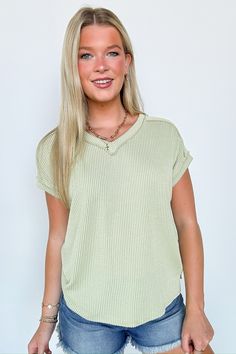 Details: Get ready to relax in style with the Maribeth Rib Knit Short Sleeve Top. This solid twist rib top features a flattering v neckline, short sleeves, and side slits for a relaxed fit. Perfect for any casual occasion, this top is the epitome of comfort and style. - Rib knit - V-neck Content: 77% POLYESTER 17% RAYON 6% SPANDEX Size + Fit: Model is 5'8" and wearing a Small - Measurements from a size small - Full length: 24.5"(Front) 27"(Back) - Chest: 44" - Waist: 42" - Sleeves: 7" Brand: 7th Solid Ribbed V-neck Knit Top, Chic Green V-neck Knit Top, Knit V-neck Top For Day Out, Trendy Ribbed Short Sleeve Top For Everyday, Casual V-neck Stretch Knit Top, Casual Stretch V-neck Knit Top, Casual V-neck Short Sleeve Top For Loungewear, Spring V-neck Soft Knit Top, V-neck Knit Top For Loungewear