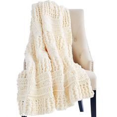 a white blanket sitting on top of a chair