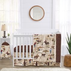 a baby crib bedding set with horse and cowboy print on it, in a white room