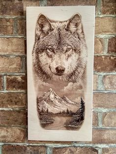 a drawing of a wolf is hanging on a brick wall